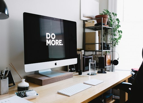 Modern workspace with iMac and organized desk representing client-focused marketing