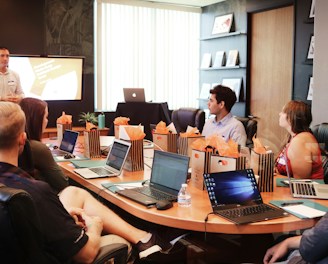 Client-focused team meeting with laptops