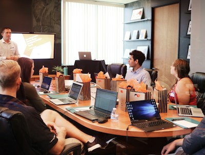 Client-focused team meeting with laptops